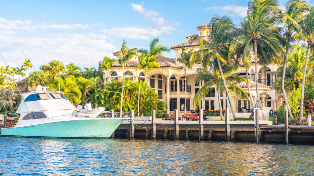 a boat is docked in front of a house on the water