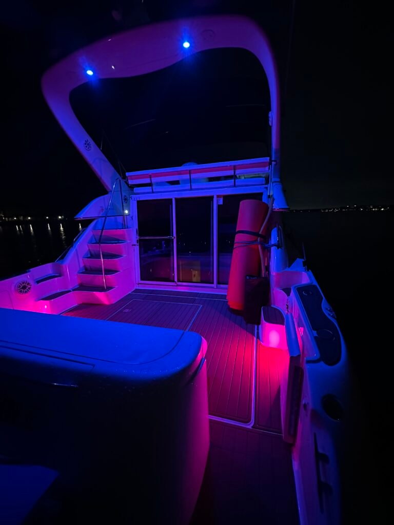 Luxurious 52ft Sea Ray Flybridge Yacht at Night with the neon lights on